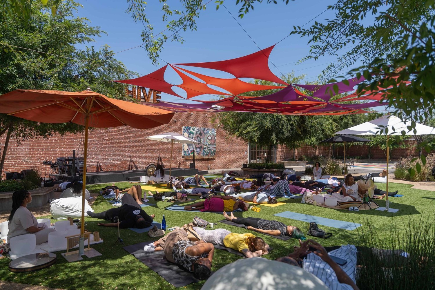 An outdoor Bloom sound bath under shade sails
