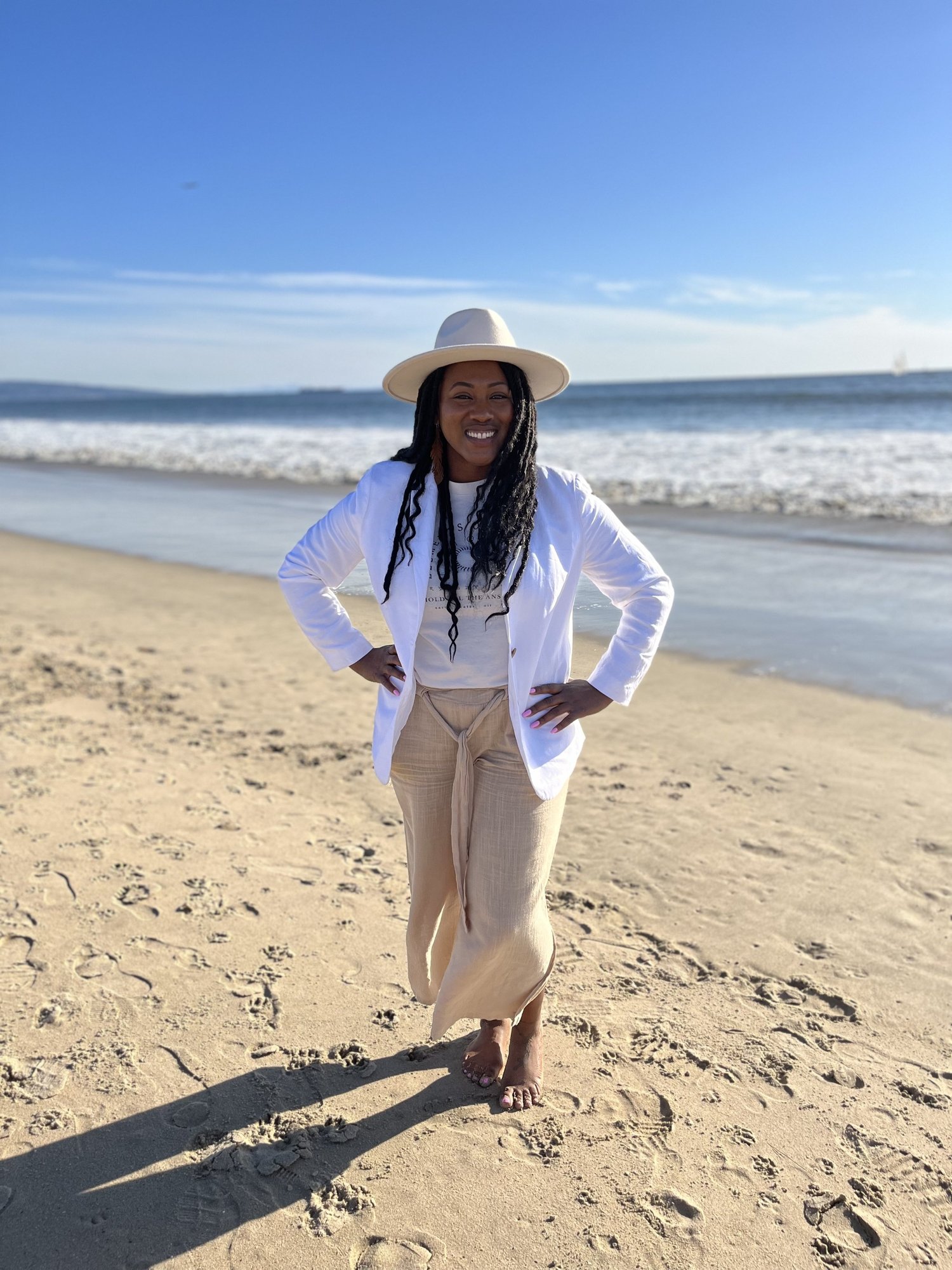 Jennifer Franklin-Moody, founder of Bloom Holistic Healing, standing on a Los Angeles beach